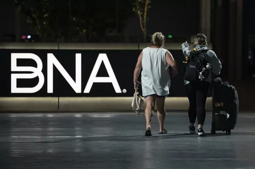 Air travelers make their way through the Nashville International Airport Tuesday, July 25, 2023 in Nashville, Tenn. A new Tennessee law that installs a state takeover of the board that oversees Nashville's airport has created confusion about who is actually running the facility. (AP Photo/George Walker IV)