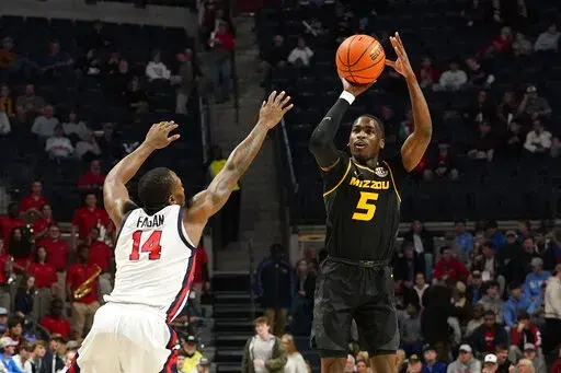 Missouri guard D'Moi Hodge (5) shoots a 3-pointer over Mississippi guard Tye Fagan (14) during the first half of an NCAA college basketball game in Oxford, Miss., Tuesday, Jan. 24, 2023. (AP Photo/Rogelio V. Solis)