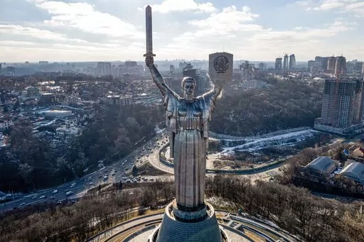 A view of Ukraine's the Motherland Monument in Kyiv Sunday, Feb. 13, 2022. The threat of war has shredded Ukraine's economy, and many Ukrainians are asking why they are the ones suffering instead of Russia. The pressure from Russian troops has closed international offices, canceled flights and caused hundreds of millions of dollars in investment to dry up within weeks. (AP Photo/Efrem Lukatsky, File)