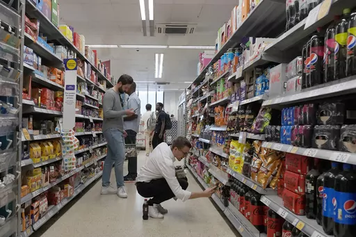 Shoppers buy food in a supermarket in London, on Aug. 17, 2022. Food prices and overall inflation will rise as temperatures climb with climate change, a new study by an environmental scientist and the European Central Bank found. (AP Photo/Frank Augstein, File)