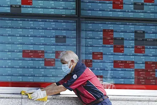 A custodian cleans up an electronic stock board showing Japan's Nikkei index at a securities firm in Tokyo, on Aug. 26, 2024. (AP Photo/Eugene Hoshiko, File)