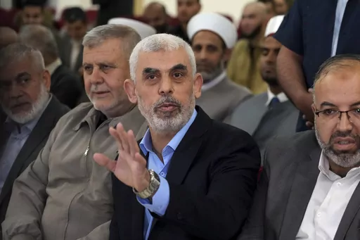 Yahya Sinwar, head of Hamas in Gaza, greets his supporters upon his arrival at a meeting in a hall on the sea side of Gaza City, on April 30, 2022. Since Hamas fighters carried out the deadliest attack on Israel in decades, Israeli officials have vowed to crush the Palestinian militant group and its enigmatic leader in Gaza, Yahya Sinwar. But seven weeks into the war, 61-year-old Sinwar remains alive, in hiding and at the helm of Hamas’ fighters as they battle Israeli forces. (AP Photo/Adel Ha