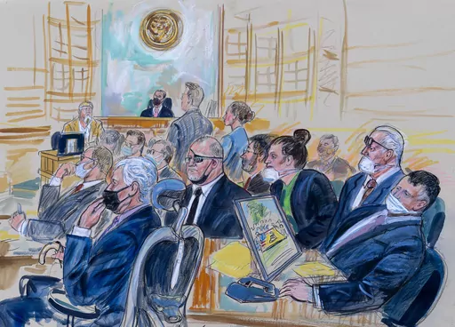 This artist sketch depicts the trial of Oath Keepers leader Stewart Rhodes and four others charged with seditious conspiracy in the Jan. 6, 2021, Capitol attack, in Washington, Oct. 6, 2022. Shown above are, witness John Zimmerman, who was part of the Oath Keepers' North Carolina Chapter, seated in the witness stand, defendant Thomas Caldwell, of Berryville, Va., seated front row left, Oath Keepers leader Stewart Rhodes, seated second left with an eye patch, defendant Jessica Watkins, of Woodsto