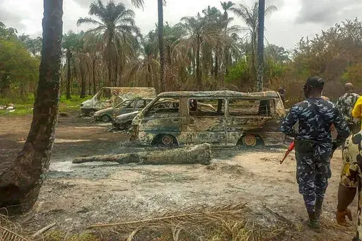 People gather Saturday April 23, 2022 at the site of an explosion that took place the day before at an illegal oil refinery in Ohaji-Egbema local government area in Imo state, southeast Nigeria. At least 100 people are feared to have died in the explosion, authorities told The Associated Press, as the search for bodies at the site and for two people suspected of being involved in the incident intensified. (AP Photo)