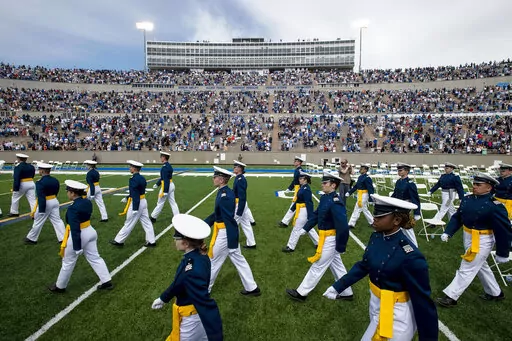 Air Force Academy cadets make their way to their seats as family and friends cheer from the stands during the United States Air Force Academy's Class of 2021 graduation ceremony at the USAFA in Colorado Springs, Colo., on May 26, 2021. Four cadets at the Air Force Academy may not graduate or be commissioned as military officers in May 2022, because they have refused the COVID-19 vaccine, and they may be required to pay back thousands of dollars in tuition costs, according to Air Force officials.