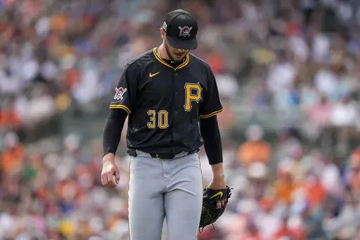 Pittsburgh Pirates starting pitcher Paul Skenes (30) returns to the dugout after the first inning of a spring training baseball game against the Baltimore Orioles, Saturday, March 1, 2025, in Sarasota, Fla. (AP Photo/Stephanie Scarbrough)
