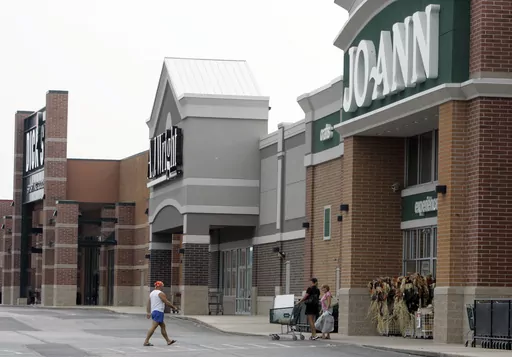 People walk into and out of a Joann store, Sept. 6, 2007, in Garfield Heights, Ohio. The fabric and crafts retailer has filed for Chapter 11 bankruptcy protection, as consumers continue to cut back on discretionary spending. In a Monday, March 18, 2024 release, the Hudson, Ohio-based company said that it expected to emerge from bankruptcy as early as the end of next month. (AP Photo/Tony Dejak, file)