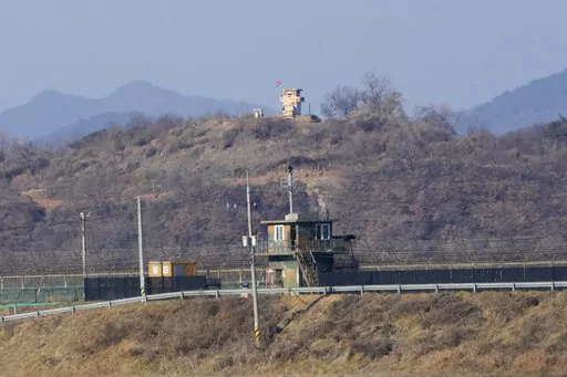 Military guard posts of North Korea, rear, and South Korea, front, are seen in Paju, near the border with North Korea, South Korea, Sunday, Jan. 2, 2022. South Korea's military said Sunday that an unidentified person crossed the heavily fortified border into North Korea. (AP Photo/Ahn Young-joon)