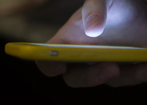 A man uses a cellphone in New Orleans, Aug. 11, 2019. On Tuesday, May 23, 2023, attorneys general across the U.S. joined in a lawsuit against a telecommunications company accused of making more than 7.5 billion robocalls to people on the national Do Not Call Registry. (AP Photo/Jenny Kane, File)