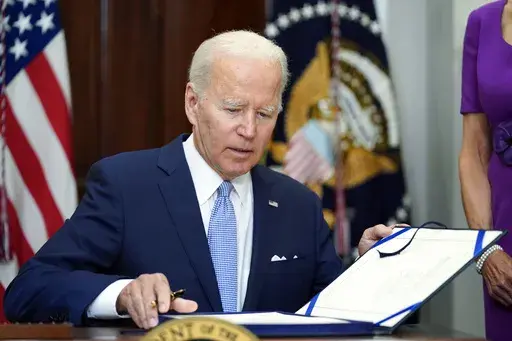 President Joe Biden signs into law S. 2938, the Bipartisan Safer Communities Act gun safety bill, in the Roosevelt Room of the White House in Washington, June 25, 2022. More than 500 people have been charged with federal crimes under new firearms trafficking and straw purchasing laws that are part of the landmark gun safety legislation President Joe Biden signed two years ago Tuesday. Some of the people were linked to transnational cartels and organized crime. That's according to a White House r