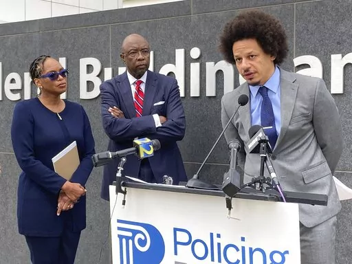 Comedian Eric André, right, speaks at a news conference outside the federal courthouse in Atlanta on Tuesday, Oct. 11, 2022, as his attorneys Allegra Lawrence-Hardy, left, and Richard Deane watch. André and comedian Clayton English filed a lawsuit Tuesday alleging that they were racially profiled and illegally stopped by Clayton County police at Hartsfield-Jackson Atlanta International Airport. They say officers singled them out during separate stops roughly six months apart because they are B