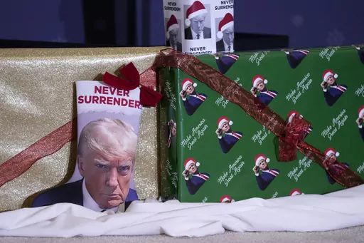 Christmas gifts are seen on the stage during a former President Donald Trump commit to caucus rally, Tuesday, Dec. 19, 2023, in Waterloo, Iowa. The field of 2024 presidential candidates may have some options for shoppers scrambling for a last-minute holiday gift. As the campaign for the White House kicks into full gear, the contenders are offering an onslaught of holiday-themed merchandise, many of which capture some of the surreal aspects of the 2024 race. (AP Photo/Charlie Neibergall, File)