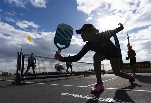 Catherine Parenteau returns the ball during a pickle ball match at the Goodyear Blimp Base Airport Wednesday, Nov. 29, 2023, in Carson, Calif. The health benefits of spending time in nature have long been established, and exercise in general improves physical and mental well-being. (AP Photo/Ryan Sun, File)