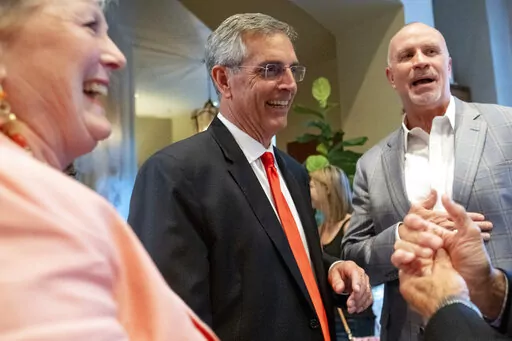 Incumbent Georgia Secretary of State Brad Raffensperger, center, and his wife Tricia arrive for an election night party on May 24, 2022, in Peachtree Corners, Ga. The House selection committee is expected to hear testimony from Raffensperger about the extraordinary pressure he faced from former President Donald Trump to "find 11,780" votes that could flip the state to prevent Joe Biden's election victory. (AP Photo/Ben Gray, File)