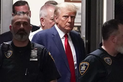 Former President Donald Trump is escorted to a courtroom, April 4, 2023, in New York. Trump’s bond has been set at $200,000 in the Georgia case accusing the former president of scheming to overturn his 2020 election loss. The bond agreement was outlined in a court filing signed by Fulton County District Attorney Fani Willis and Trump’s defense attorneys. (AP Photo/Mary Altaffer, File)