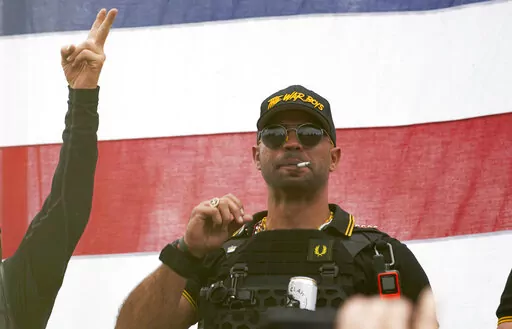 Proud Boys leader Enrique Tarrio wears a hat that says The War Boys and smokes a cigarette at a rally in Delta Park on Sept. 26, 2020, in Portland, Ore. Tarrio, the former top leader of the far-right Proud Boys extremist group, and other members were indicted Monday, June 6, 2022, on seditious conspiracy charges for what federal prosecutors say was a coordinated attack on the U.S. Capitol to stop Congress from certifying President Joe Biden's 2020 electoral victory.(AP Photo/Allison Dinner, File