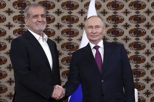 Russian President Vladimir Putin, right, and Iranian President Masoud Pezeshkian pose for a photo at their meeting in Ashgabat, Turkmenistan, on Oct. 11, 2024. (Alexander Shcherbak, Sputnik, Kremlin Pool Photo via AP, File)