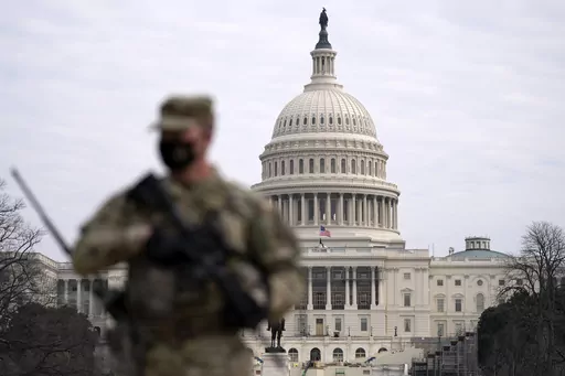 A member of the National Guard patrols the area outside of the U.S. Capitol at the Capitol in Washington, Wednesday, Feb. 10, 2021. The House passed a defense policy bill Thursday, Dec. 14, 2023, that authorizes the biggest pay raise for troops in more than two decades, overcoming objections from some conservatives concerned the measure did not do enough to restrict the Pentagon's diversity initiatives, abortion travel policy and gender-affirming health care for transgender service members. (AP 