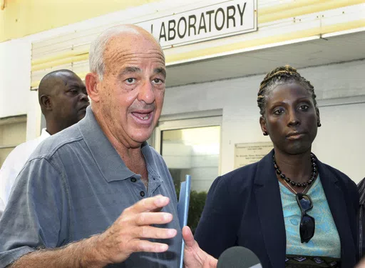 Pathologist Dr. Cyril Wecht, center, talks to the media while Bahamas' head coroner Linda Virgil, right, and attorney Michael Scott, left, listen outside the Rand Laboratory morgue at the Princess Margaret Hospital in Nassau, Bahamas, Sept. 17, 2006. Wecht, a pathologist and attorney whose biting cynicism and controversial positions on high-profile deaths such as President John F. Kennedy’s 1963 assassination caught the attention of prosecutors and TV viewers alike, died Monday, May 13, 2024. 
