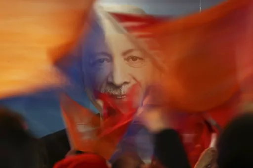 Supporters of President Recep Tayyip Erdogan wave flags in front of his picture in Istanbul, on March 31, 2019. Erdogan, who is seeking a third term in office as president in elections in May, marks 20 years in office on Tuesday, March 14, 2023. (AP Photo/Emrah Gurel, File)