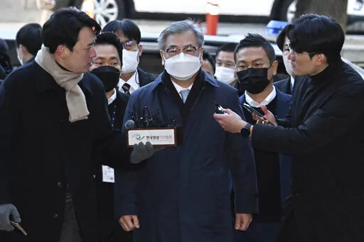 Former South Korean National Security Director Suh Hoon, center, arrives at the Seoul Central District Court in Seoul, South Korea, Friday, Dec. 2, 2022. South Korean prosecutors arrested the country’s former national security director on Saturday over suspicions that he engaged in a cover-up to hide details and distort the circumstances surrounding North Korea’s killing of a South Korean fisheries official near the rivals’ sea boundary in 2020. (Han Sang-kyun/Yonhap via AP)