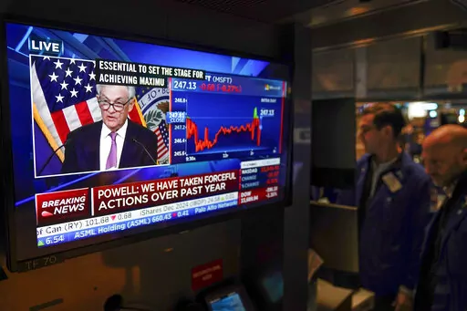 Traders on the floor at the New York Stock Exchange watch Federal Reserve Chair Jerome Powell's news conference after the Federal Reserve interest rate announcement in New York, Wednesday, Feb. 1, 2023. (AP Photo/Seth Wenig)