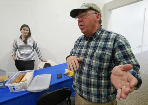 Co owner of Building Resilient Solutions, Kerry Shackelford, right, gestures as he describes the process for testing wood along with Paige Pollard, left, at their lab Tuesday, Oct. 4, 2022, in Suffolk, Va. Whenever historic homes get flooded, building contractors often feel compelled by government regulations to rip out the water-logged wood flooring, tear down the old plaster walls and install new, flood-resistant materials. But Virginia restorers Paige Pollard and Kerry Shackelford say they ca