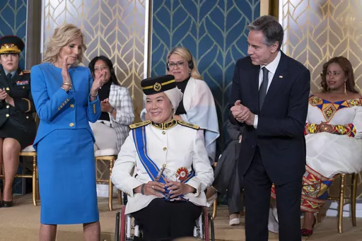 Malaysian Senator Datuk Ras Adiba Radzi receives the International Women of Courage Award from Secretary of State Antony Blinken with first lady Jill Biden, during a ceremony in the East Room of the White House, in Washington, to commemorate International Women's Day, Wednesday, March 8, 2023. (AP Photo/Manuel Balce Ceneta)