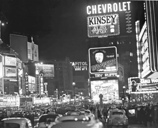 The Times Square section of New York City is pictured with the lights still on before 100 non-striking maintenance men pulled the switches in a sympathy demonstration, 1950.  Genealogists and historians can get a microscopic look at sweeping historical trends when individual records from the 1950 census are released this week. Researchers view the records that will be released Friday, March 31, 2022 as a gold mine, and amateur genealogists see it as a way to fill gaps in family trees.   (AP Phot