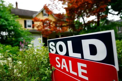 A sale sign stands outside a home in Wyndmoor, Pa., Wednesday, June 22, 2022. If you’re settling into a new home, you might be looking to fill it with furniture. But after your rent or mortgage, security deposit and moving expenses, there might not be much left over for your dream couch or dining room set.  AP Photo/Matt Rourke)(