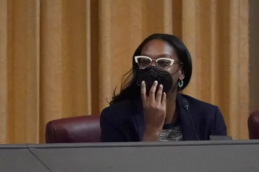 Task Force Chair Kamilah Moore listens to public comment during a meeting by the Task Force to Study and Develop Reparation Proposals for African Americans in Oakland, Calif., Wednesday, Dec. 14, 2022. (AP Photo/Jeff Chiu)