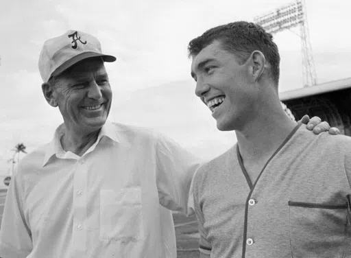 Alabama coach Bear Bryant, left, talks with his former star quarterback Steve Sloan, right, after practice in Miami for the Orange Bowl game New Years' night against Nebraska, Dec. 29, 1968. Former college coach and administrator Sloan, who played quarterback and served as athletic director at Alabama. has passed away. He was 79. Sloan died Sunday, April 14, 2024, after three months of memory care at Orlando Health Dr. P. Phillips Hospital, according to an obituary from former Alabama sports inf