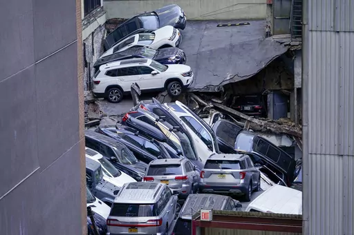 FILE — Cars are seen piled on top of each other at the scene of a partial collapse of a parking garage in the Financial District of New York, April 18, 2023, in New York. After the deadly collapse of a parking structure in lower Manhattan, New York City building officials swept through dozens of parking garages and ordered four of them to immediately shutter because of structural issues that "deteriorated to the point where they were now posing an immediate threat to public safety." (AP Photo/