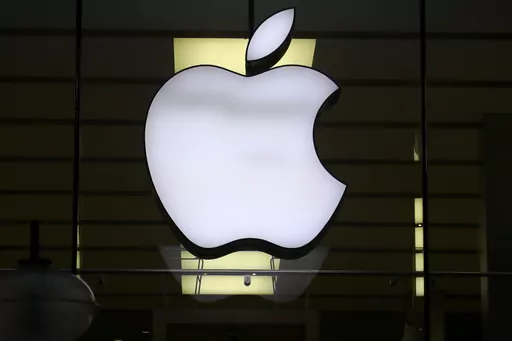 The Apple logo is illuminated at a store in the city center of Munich, Germany, Dec. 16, 2020. Apple Inc. is raising the prices for its AppleTV+ streaming and Arcade gaming plans, as well as its bundled Apple One service that includes streaming, music and other subscriptions. (AP Photo/Matthias Schrader, File)