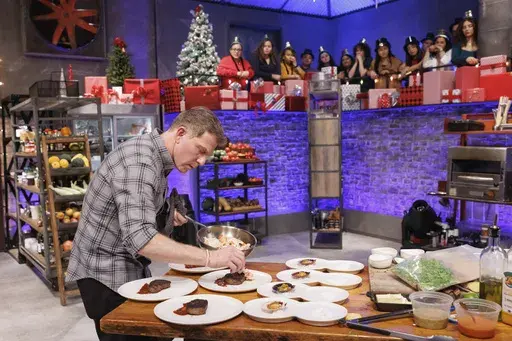This image released by The Food Network shows Bobby Flay during an episode of the cooking series "Beat Bobby Flay: Holiday Throwdown." (Stephen Davis Phillips/Food Network via AP)