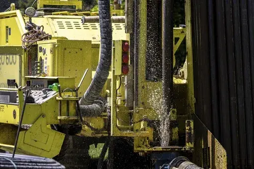 Groundwater squirts up during drilling for a geothermal heating and cooling system at a home in White Plains, N.Y., May 8, 2023. A community in Framingham, Mass., will soon become one of the first in the U.S. to be heated with geothermal connected to each other. (AP Photo/Julia Nikhinson, File)