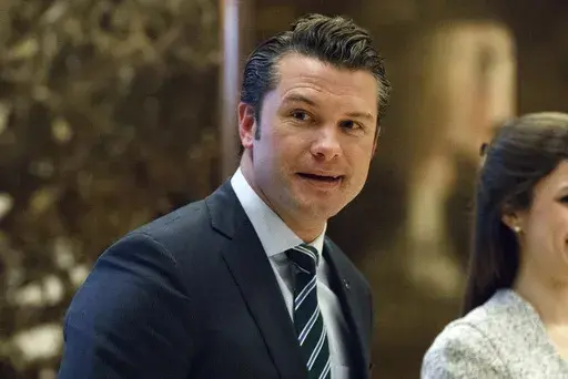 Pete Hegseth walks to an elevator for a meeting with President-elect Donald Trump at Trump Tower in New York, Dec. 15, 2016. (AP Photo/Evan Vucci, File)