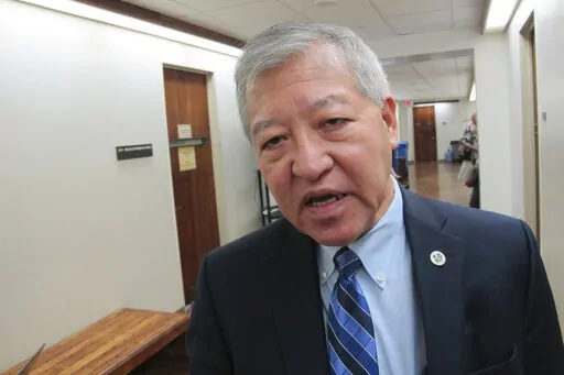 Honolulu Prosecuting Attorney Keith Kaneshiro talks to The Associated Press in Honolulu, on March 2, 2016. A U.S. grand jury has indicted Honolulu's former top prosecutor, Kaneshiro, and four others, alleging employees of an engineering and architectural firm bribed Kaneshiro with campaign donations in exchange for his prosecution of a former company employee. (AP Photo/Cathy Bussewitz, File)