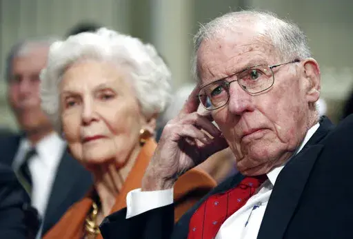 In this Feb. 19, 2013 file photo, former Gov. William Winter, right, and wife Elise listen to panelists at a symposium on the Future of Mississippi and the South on Winter's 90th birthday at the Old Capitol Museum in Jackson, Miss. An event on May 3, 2022, in Jackson will celebrate the lives of the couple. William Winter was 97 when he died in December 2020, and Elise Winter was 95 when she died in July 2021. (AP Photo/Rogelio V. Solis, File)