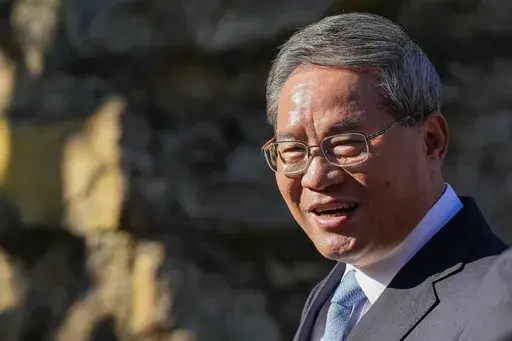 Chinese Premier Li Qiang reacts during a visit to Adelaide Zoo, Australia, Sunday, June 16, 2024. Li is on a relations-mending mission with panda diplomacy, rock lobsters and China's global dominance in the critical minerals sector high on the agenda during his four day visit to Australia. (Asanka Brendon Ratnayake/Pool Photo via AP)