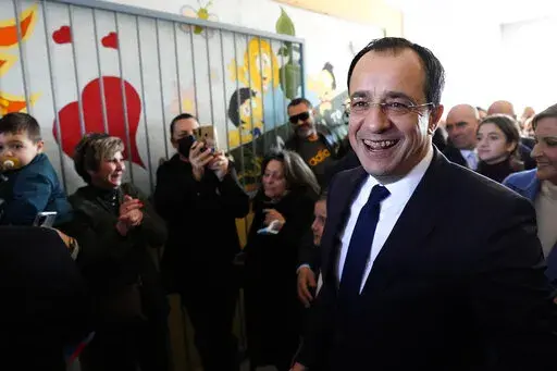 Presidential candidate Nikos Christodoulides smiles as walks with his supporters after casting his vote during the presidential elections in Geroskipou in south west coastal city of Paphos, Cyprus, Sunday, Feb. 12, 2023. Voting has started in a runoff to elect ethnically split Cyprus' eighth new president, pitting a former foreign minister who campaigned as a unifier eschewing ideological and party divisions against a popular veteran diplomat. Some 561,000 citizens are eligible to vote and both 