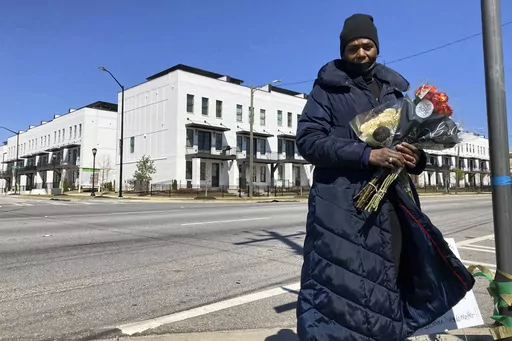 Valerie Handy-Carey stands at Donald Lee Hollowell Parkway and Finley Avenue on March 19, 2023, in Atlanta. Several months earlier, her daughter Brittany Glover was hit by a car and died while trying to cross the intersection. With pedestrian deaths in the U.S. at their highest in four decades, citizens across the nation are urging lawmakers to break from transportation spending focused on car culture. Atlanta, she said, needs to do more to protect pedestrians and cyclists. (AP Photo/Sharon John