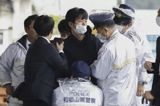 A man who was later identified as Ryuji Kimura is arrested after what appeared to be a pipe bomb was thrown at Japanese Prime Minister Fumio Kishida during his visit at a port in Wakayama, western Japan, on April 15, 2023. Prosecutors in Japan indicted the 24-year-old man Wednesday, Sept. 6, 2023 on attempted murder and other charges in the explosive attack on Prime Minister Fumio Kishida in April, Japanese media reported. (Kyodo News via AP, File)