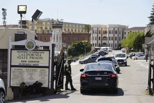 A guard checks vehicles entering the main gate at San Quentin State Prison on April 12, 2022, in San Quentin, Calif. California Gov. Gavin Newsom plans to transform a state prison home to the nation's largest number of inmates on death row into a facility where prisoners can receive education, training and rehabilitation before reentering society. Newsom's office announced the new plans for San Quentin State Prison on Thursday, March 16, 2023. (AP Photo/Eric Risberg, File)