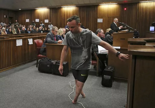 FILE — Oscar Pistorius, walks on his stumps during argument in mitigation of sentence by his defense attorney Barry Roux in the High Court in Pretoria, South Africa, Wednesday, June 15, 2016. An appeals court found Pistorius guilty of murder and not a lesser charge of culpable homicide for the shooting death of his girlfriend Reeva Steenkamp. Pistorius shot his girlfriend Reeva Steenkamp more than a decade ago in a Valentine's Day killing that jolted the world and shattered the image of a spor