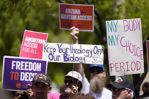 Abortion rights supporters gather outside the Capitol, Wednesday, April 17, 2024, in Phoenix. Arizona doctors could come to California and provide abortions for their patients under a new proposal announced Wednesday, April 24, 2024, by Gov. Gavin Newsom aimed at circumventing a state law that bans nearly all abortions in that state. (AP Photo/Matt York, File)