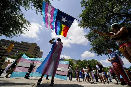 Demonstrators gather on the steps to the State Capitol to speak against transgender-related legislation bills being considered in the Texas Senate and Texas House, May 20, 2021 in Austin, Texas. The Texas Supreme Court is allowing the state to investigate parents of transgender youth for child abuse. But in a mixed ruling Friday, May 13, 2022, the court also handed a victory to one family that was among the first contacted by child welfare officials following an order by Republican Gov. Greg Abb