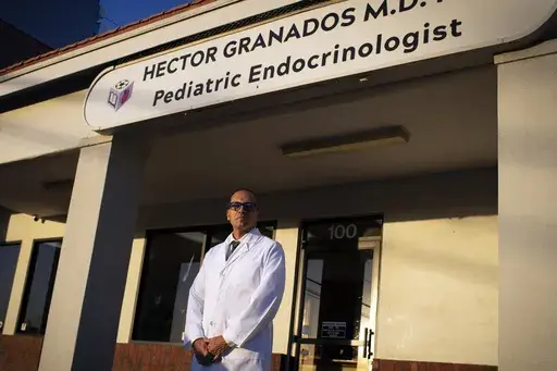 Pediatric endocrinologist Dr. Hector Granados poses for a photo outside his private practice in El Paso, Texas, Tuesday, Jan. 21, 2025. (AP Photo/Andres Leighton)