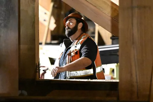 A construction worker looks up at the I-10 freeway, which was closed by fire on Nov. 19, 2023, in Los Angeles. On Friday, March 8, 2024, the U.S. government issues its February jobs report. (AP Photo/Alex Gallardo, File)