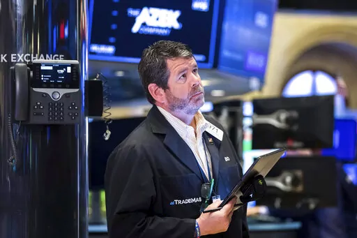 In this photo provided by the New York Stock Exchange, trader James Macgilvray works on the floor, Monday, June 13, 2022. Fears about a possible recession are pounding markets worldwide on Monday, and Wall Street's S&P 500 tumbled into the maw of what's known as a bear market after sinking more than 20% below its record set early this year. (Courtney Crow/New York Stock Exchange via AP)